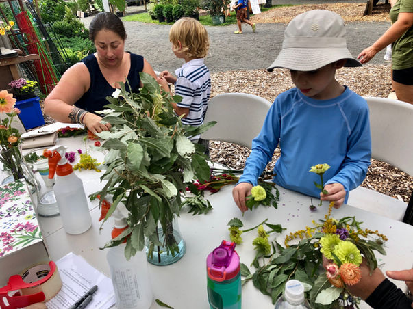 Children arranging flowers in a floral design workshop