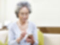 Older woman texting - receiving a text from healthcare at doctor's office