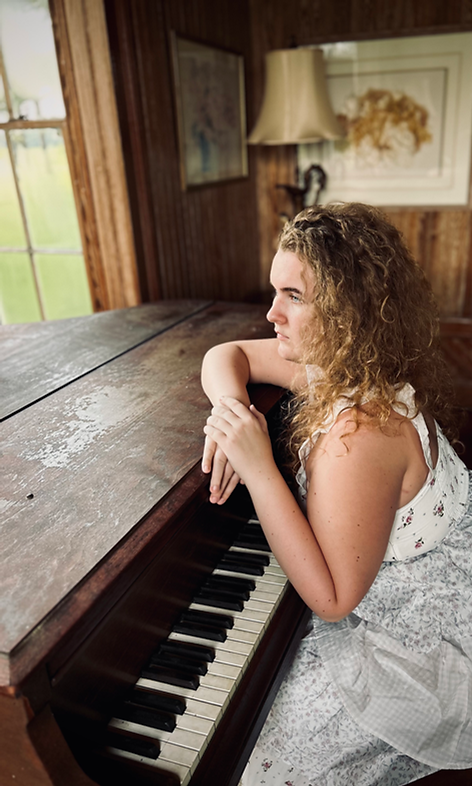 A girl sitting at the piano