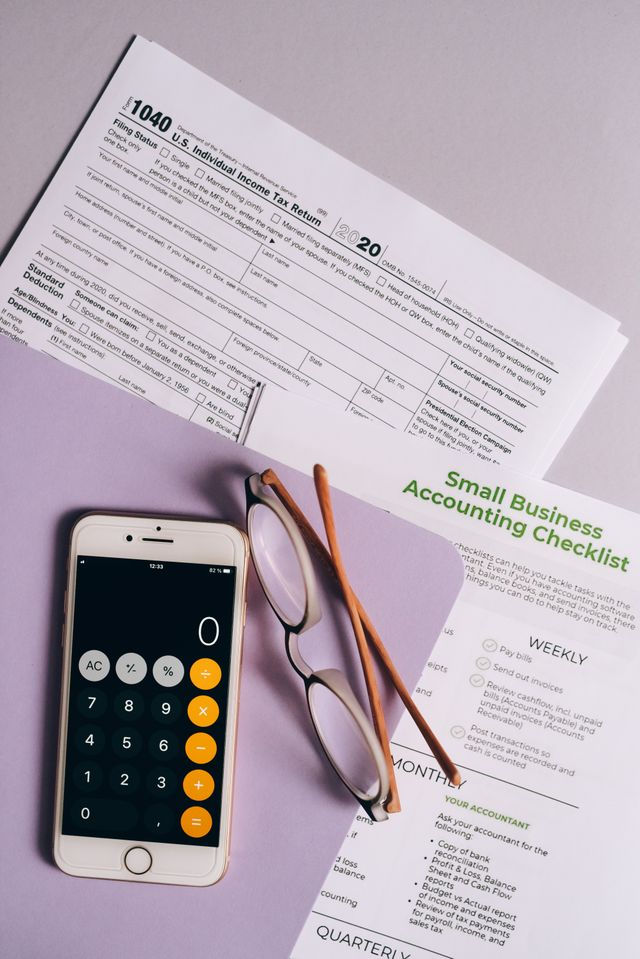 Tax Form, calculator and glasses using monthly bookkeeping for accurate tax filing