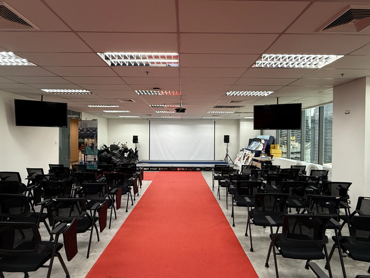 Existing GOFX seminar area used for event equipment and backdrop storage before the space was reorganised and redesigned.