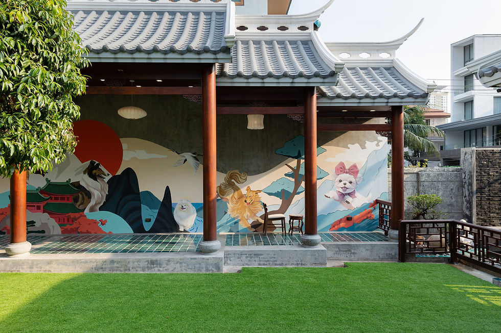 Asian-style pavilion with mural of animals and scenic landscape. Bright colors, green lawn, and tree. Tranquil and artistic setting.