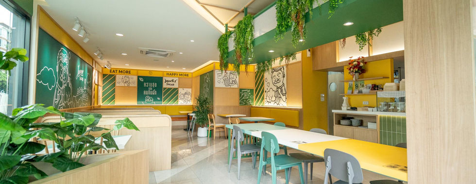 Interior seating area of Jones Salad Bangchak Romklao branch featuring compact modern healthy restaurant design with clean layout