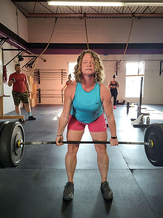 Strong woman deadlifting weights at a gym in Orillia