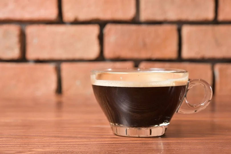A smooth Americano coffee served in a cup, highlighting its less intense flavor and larger size.