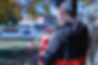 An instrumental student stands outside and plays the trumpet.