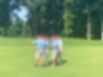 People discussing a golf hole.