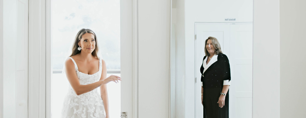 Bride seeing mother’s reflection in mirror during getting ready