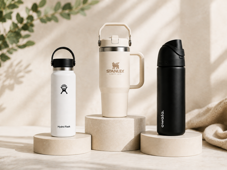 Hydro Flask vs. Stanley vs. Owala reusable water bottles displayed together in a minimalist studio setting for a side-by-side comparison.