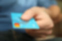 An individual handing a debit card