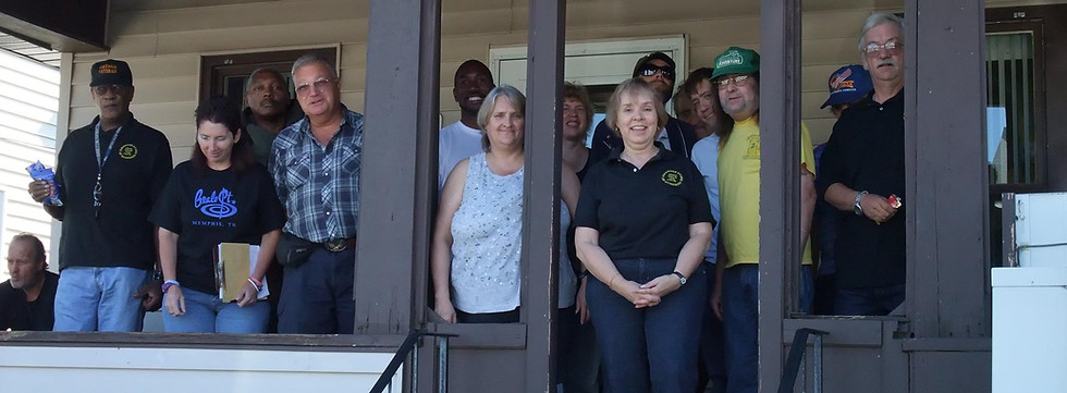 A group poses for a photo outside of The Stand