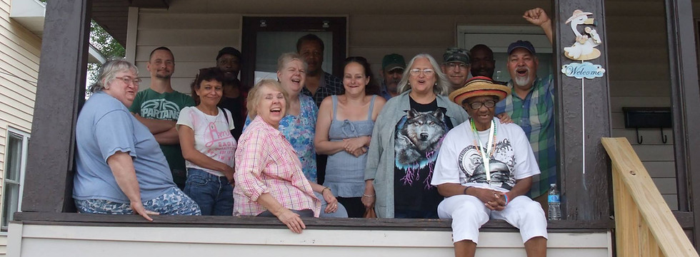 A group poses outside of The Stand of Muskegon