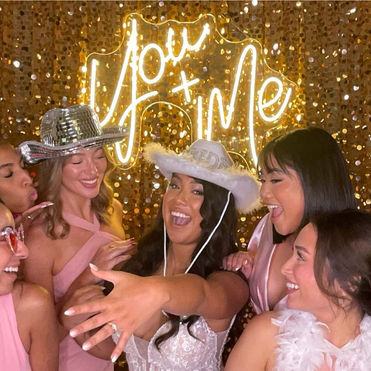 Bride and guests using photo booth wearing our cowgirl prop hats