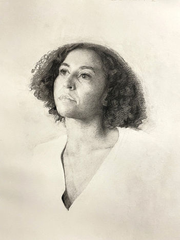 Portrait of a woman done in pencil work. The artwork focuses on the face and shoulders of the woman fading into a blank, undone background. She has a short, curly bob and a neutral expression looking up and to the left.