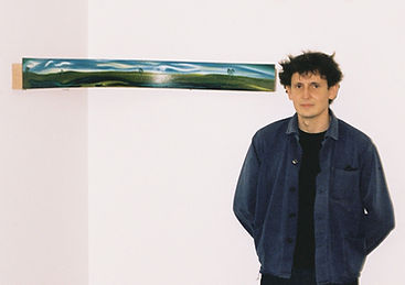 Man standing in front of a white wall next to a panorama-shaped painting that curves around a corner.