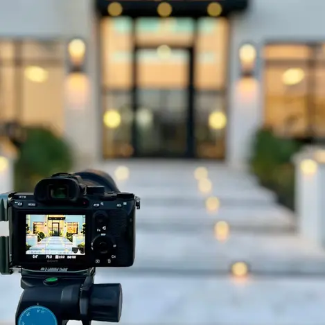 Camera on a tripod photographing a residential property, representing professional real estate photography for rental listings.