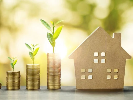 Stacks of coins with plants growing from them next to a wooden house model, symbolising smart property investment and increasing rental return.