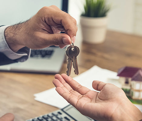 Landlord handing house keys to a new tenant after completing the tenant selection process in New Zealand.