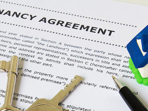 Tenancy agreement document with house model and keys representing the rental process from listing a property through to signing a lease.