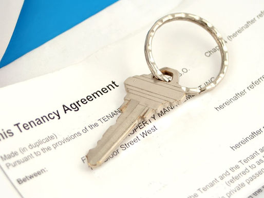 House key placed on a tenancy agreement document representing the tenant vetting and selection process for rental properties.