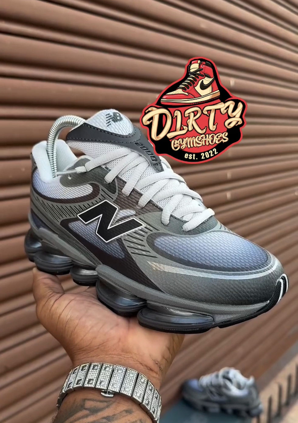 New Balance ABZORB 2000 Dark Gray shoe held by hand