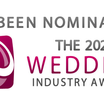 Wedding Industry Awards nomination badge for 2026 with a pink logo and bold text on a white background. Mood is celebratory.
