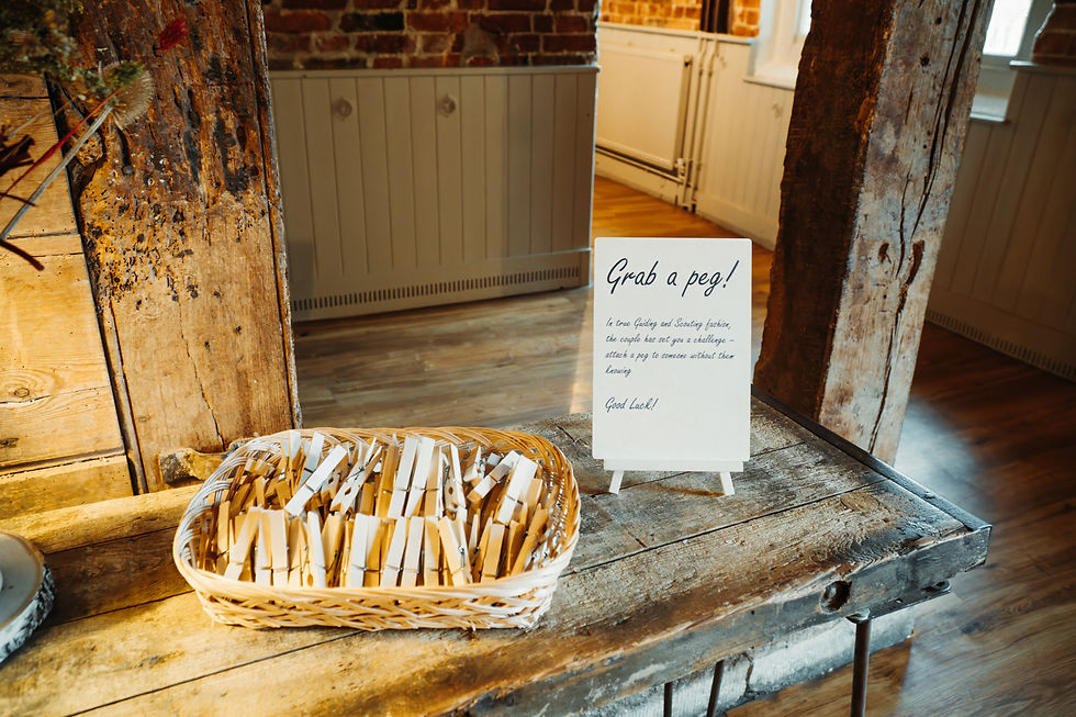 Scout-inspired wedding peg challenge sign at Sopley Mill.
