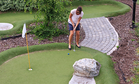 Women playing miniature golf
