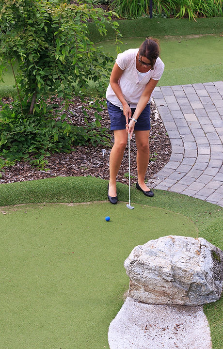 Women playing miniature golf
