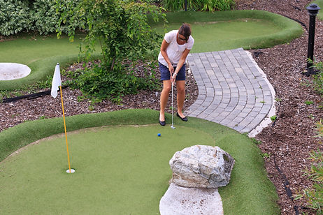 Women playing miniature golf