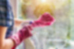 woman-clean-window-pane-with-rag-soap-suds-cleaning-with-detergent-hands-pink-protective-g