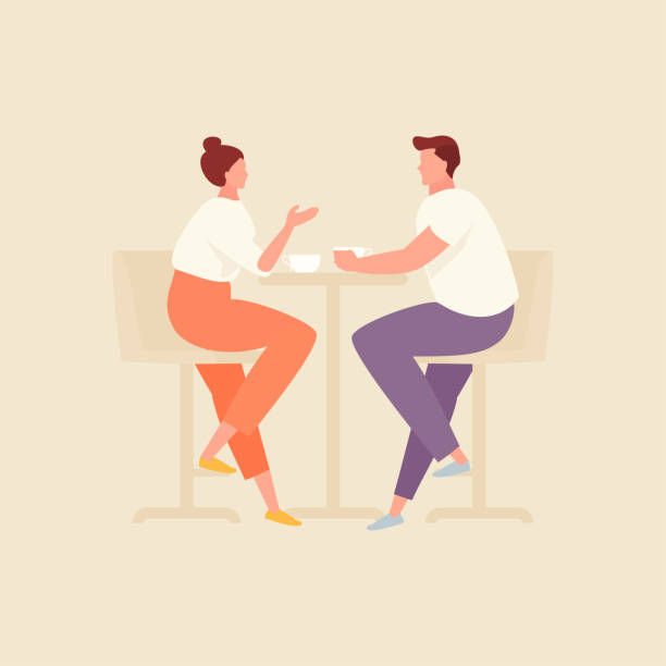 a couple having a conversation sitting at a table