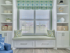 Craft room with custom window seat with built in storage.