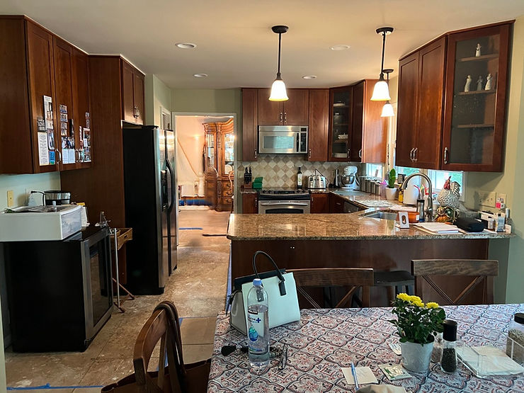 Dated kitchen with dark cabinets and countertops