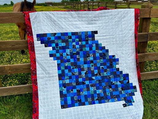 The Show-Me State Missouri quilt in a field with a horse