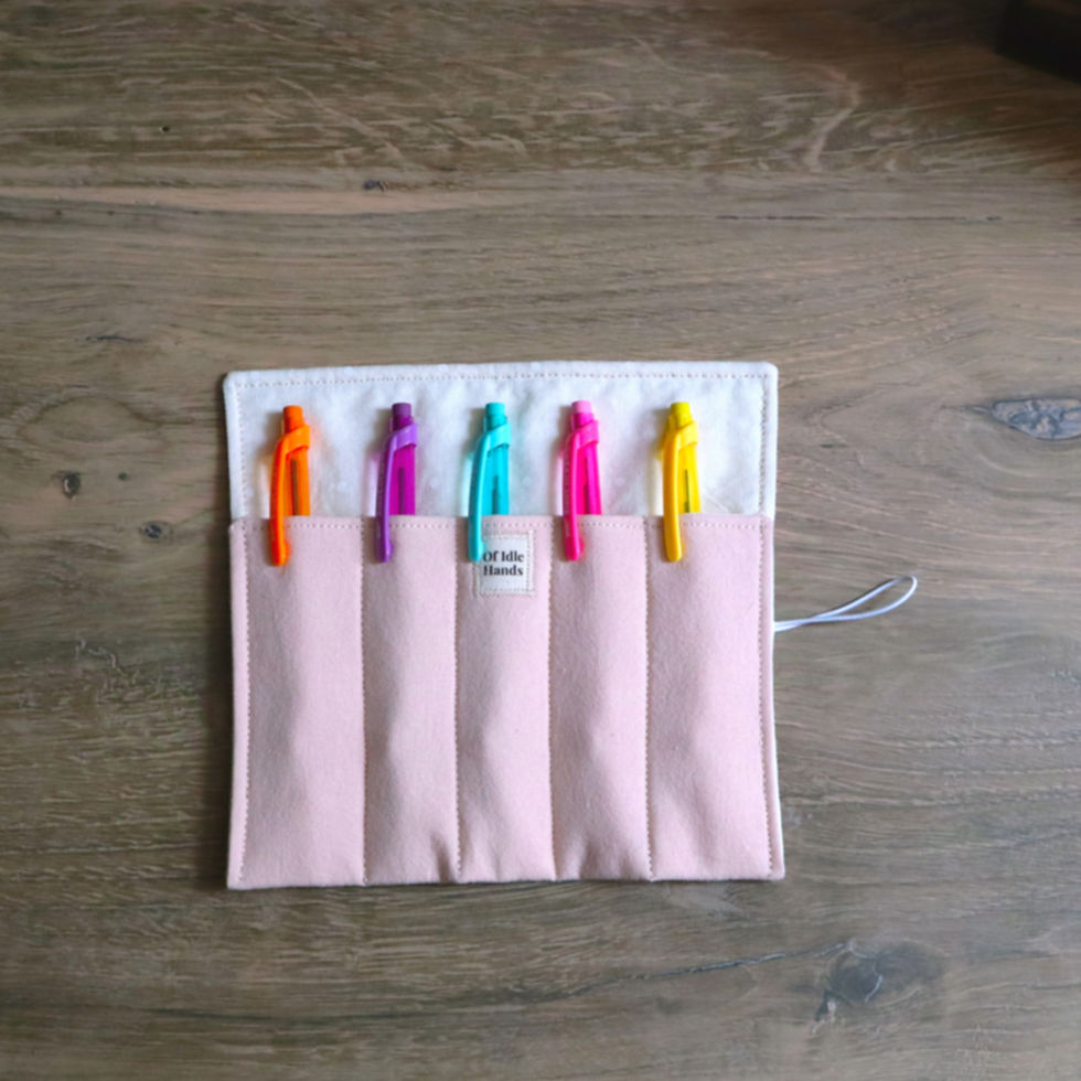 Blush pink five-slot pen roll case holding colorful pens
