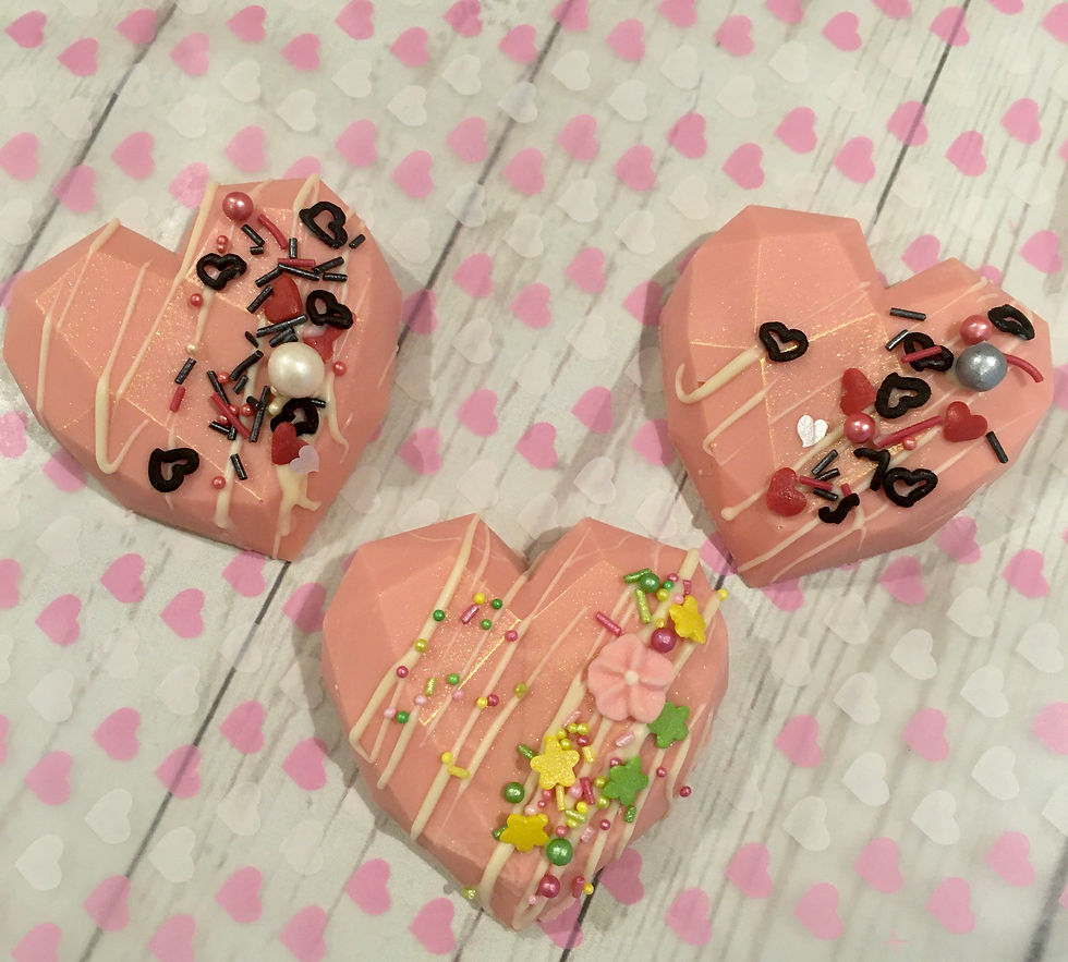 Thumbnail: Photo of chocolate cake hearts a moist chocolate or vanilla filling covered with candy melts and sprinkle.
