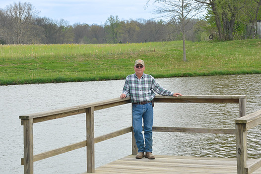 Jeff Iceberg standing on dock at pond