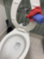 Professional office cleaning services Atlanta sanitizing a toilet seat