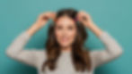 a woman refreshing her hairstyle with dry shampoo and securing it with bobby pins and hair clips.