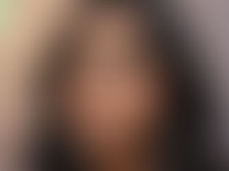 Indian woman wearing Fall 2025 makeup trend: bold emerald and copper eyeshadow with soft terracotta blush, nude lips, and natural radiant base