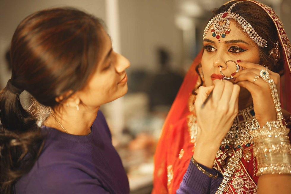 Professional makeup artist applying bridal makeup to an Indian bride during hands-on bridal makeup training at First Foundation Pro, Hyderabad's leading professional makeup academy for bridal makeup courses, hairstyling classes and beauty certification.
