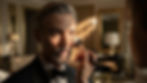 A man applying finishing powder with a makeup brush, creating a refined look suitable for a formal event.