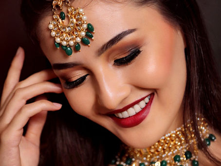 Celebrity-inspired glam makeup with soft smokey eyes, bold red lips and luxury jewelry by First Foundation Pro makeup academy in Hyderabad specializing in professional makeup training.