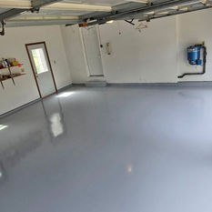 High gloss single color epoxy flooring added to the interior of a residential garage space finished by Rescue Concrete of Springfield, Illinois