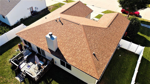 Aerial view of a residential home with a roof replacement by Copper Creek Contractors of Central Illinois.