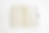 Thumbnail: Open black journal showing two blank, lined pages with a golden ribbon bookmark marking the center fold.