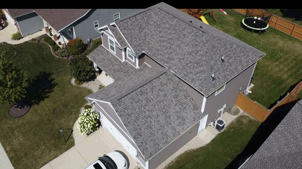 Large modern home with a new residential roof completed by Copper Creek Contractors of Central Illinois