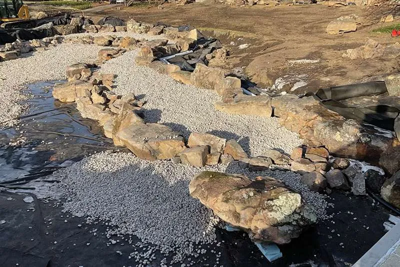 An outdoor commercial space with unfinished landscaping. 