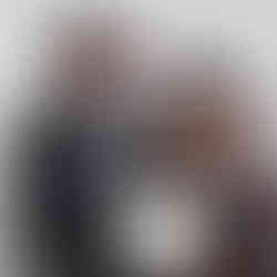 A man and a woman wearing cowboy hats holding an award together